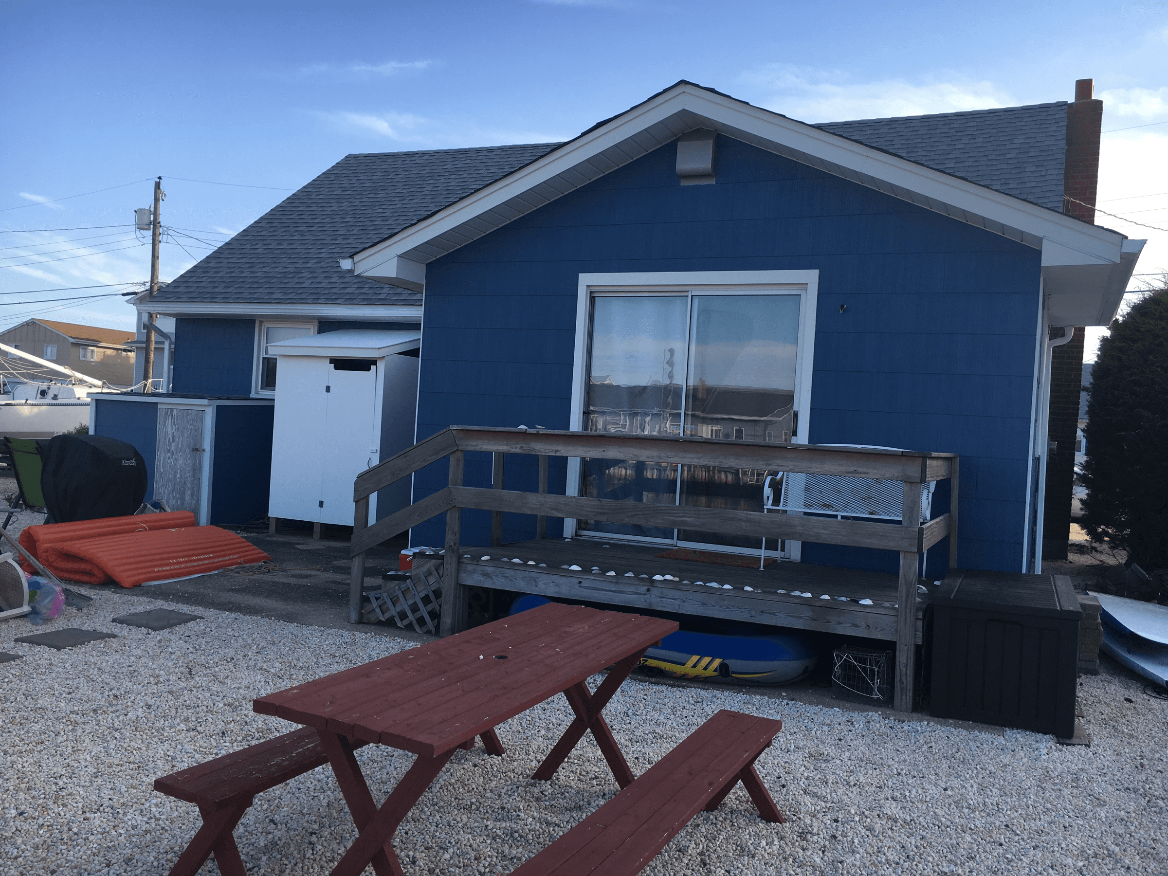 The same rear wall with the siding painted blue and the trim white, after painting