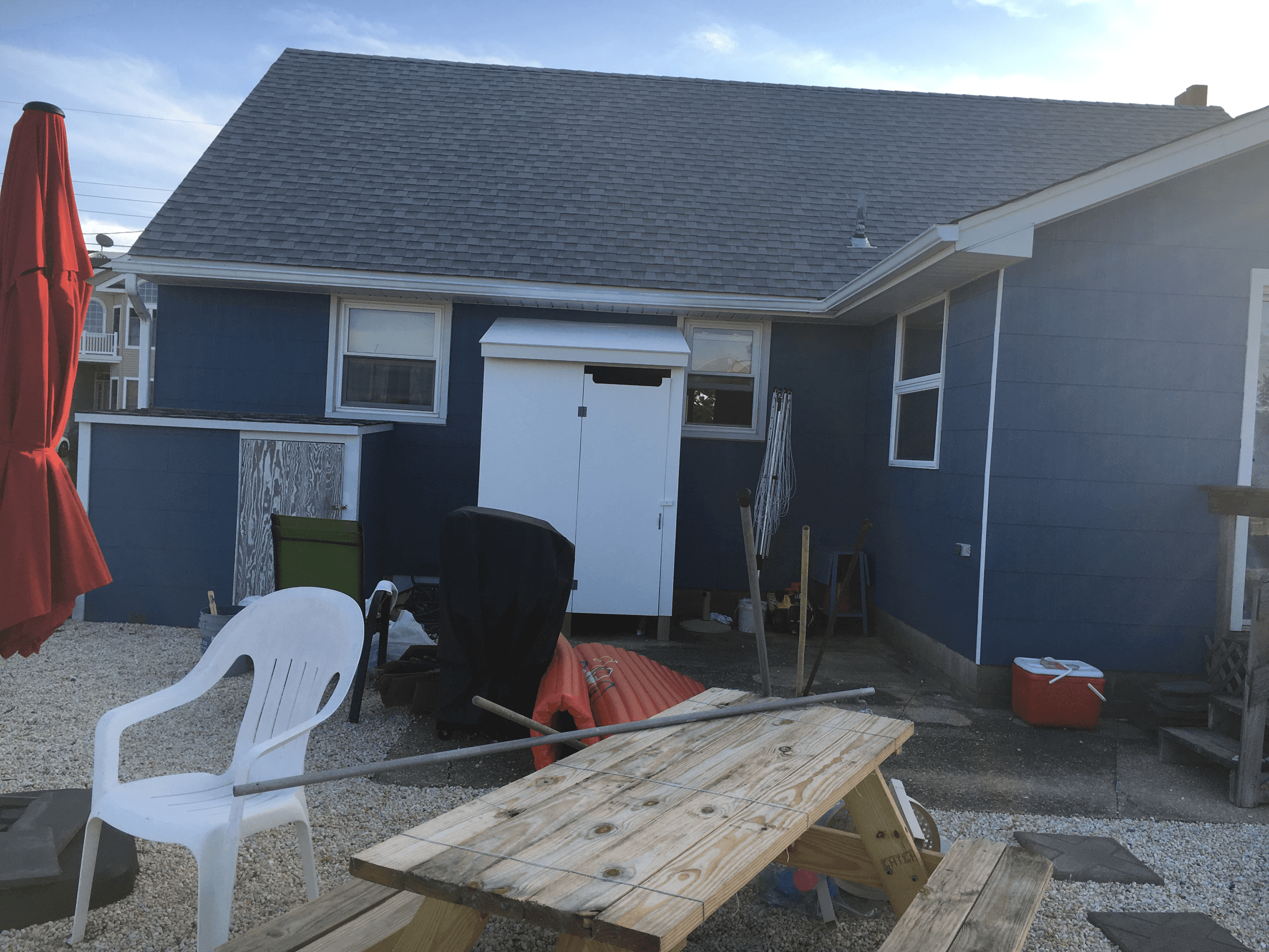 The same corner with blue siding, after painting