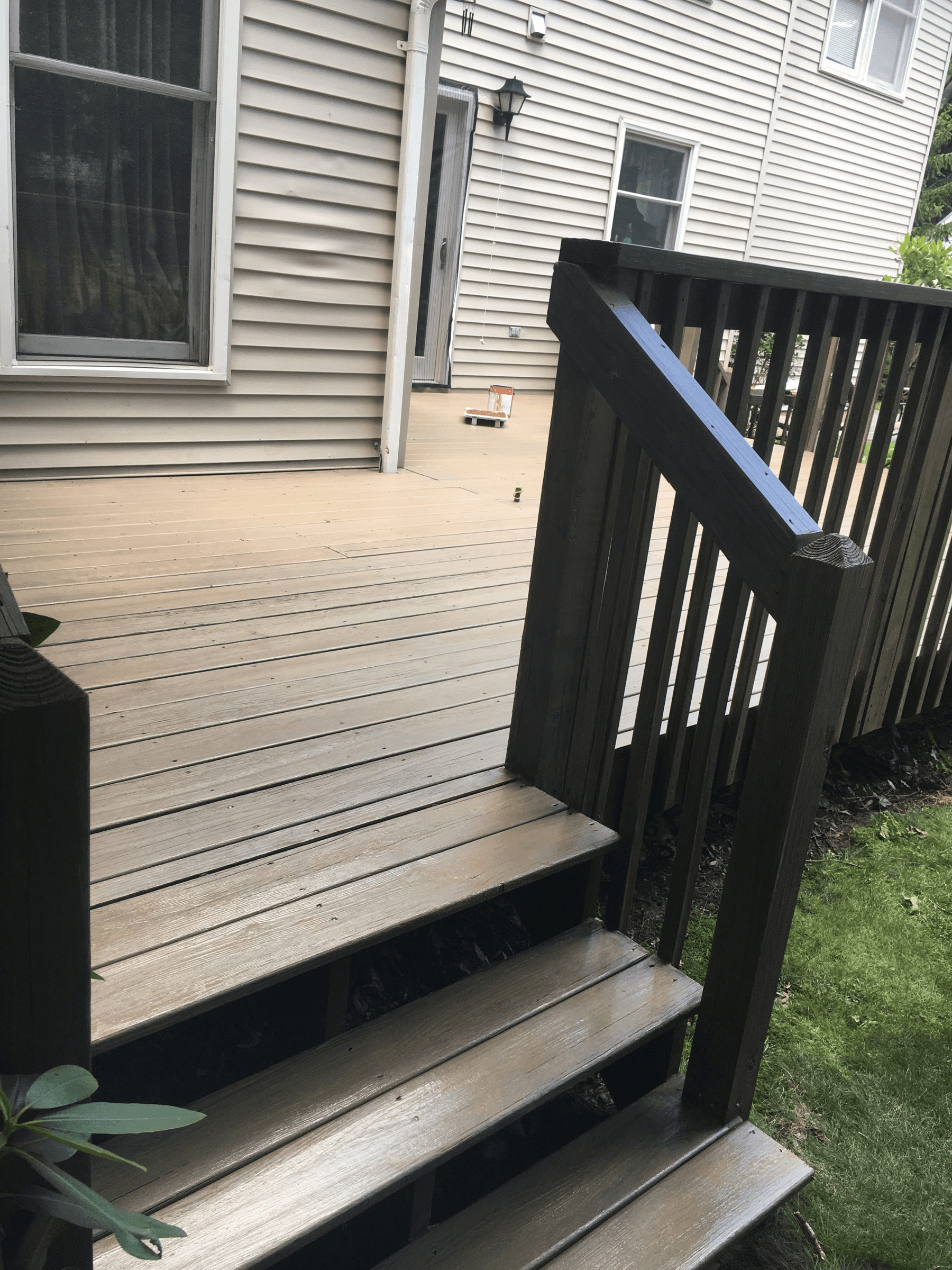 Stained deck with dark railings and steps
