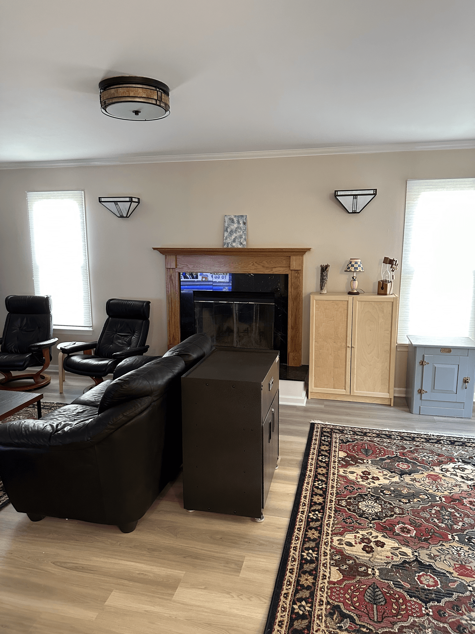 The same living room with the fireplace wall painted a light neutral, after painting