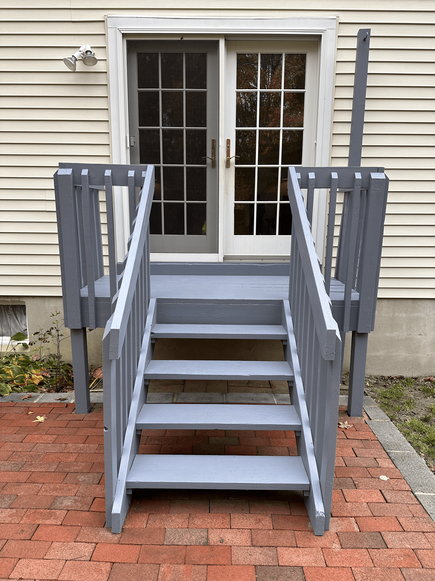 The same back stairs and landing repainted gray, after painting